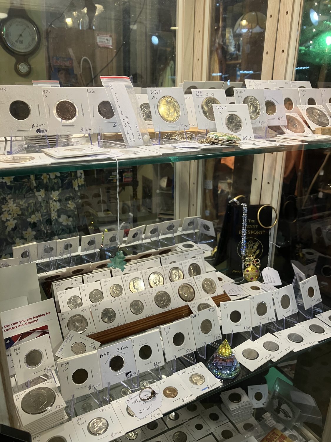 Collectible coin case at Abigail Page Antique Mall in Hudson, WI — rows of graded coins in labeled flips